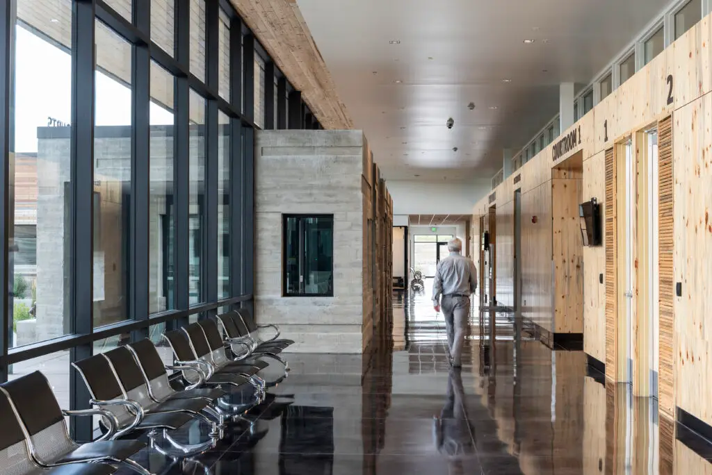 Hallway of Sweetwater County Justice Center courtrooms, featuring seating areas, entrances, and more.