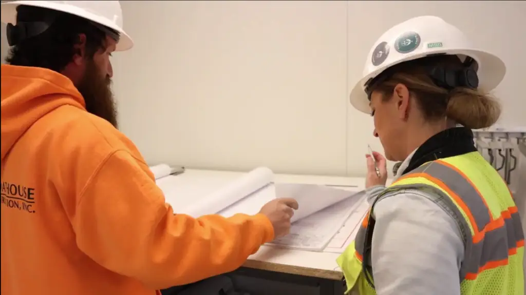 Groathouse Construction team reviews plans of the new Powell Library as construction begins