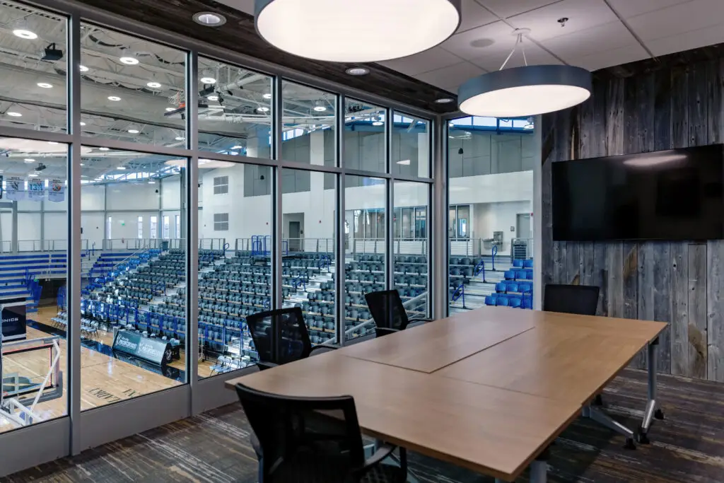 Post construction of the newly built Gillette College Pronghorn Center in Gillette, Wyoming completed by Groathouse Construction featuring the meeting room overlooking the gymnasium