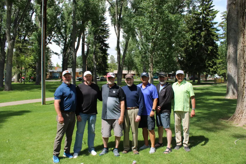 Leadership team of Groathouse Construction standing in a Wyoming park